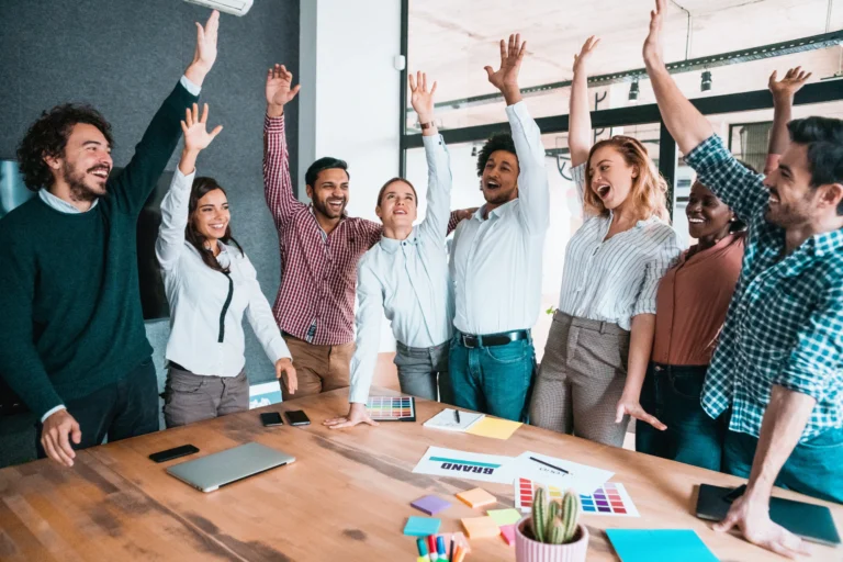 Strategies to Boost Team Motivation and Morale Employees showing high morale and collaboration